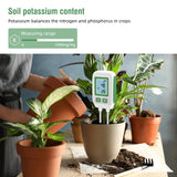 An NPK soil meter inserted in soil, indicating moisture levels for optimal plant care. 