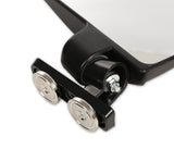 Close-up of a black mirror featuring two wheels, showcasing its sleek design and reflective surface.